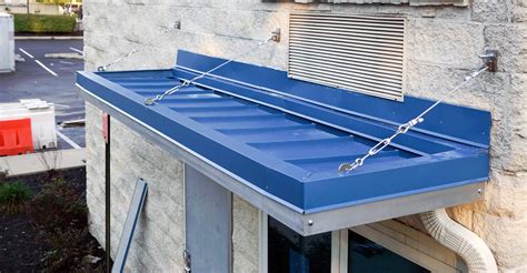 standing seam angled metal canopy detail with support bracket above|107316.16 canopy.